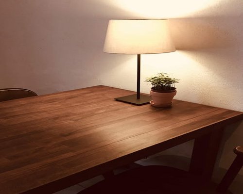 Soft diffuse natural ambient light hitting a wooden desk perfectly positioned for comfortable daily reading